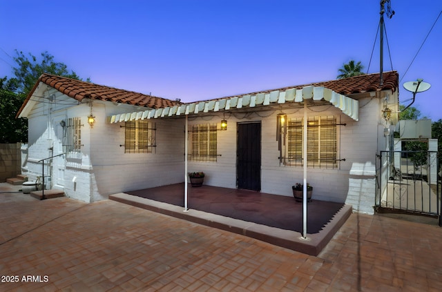 541 W Vernon Ave, Phoenix, AZ 85003 - view of front of home with a tile roof and a patio