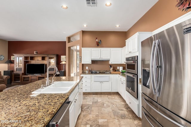 kitchen featuring sink, white cabinetry, appliances with stainless steel finishes, and dark stone countertops