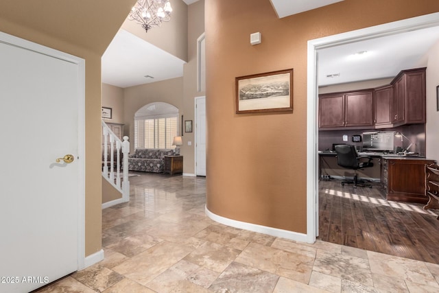 hall featuring an inviting chandelier