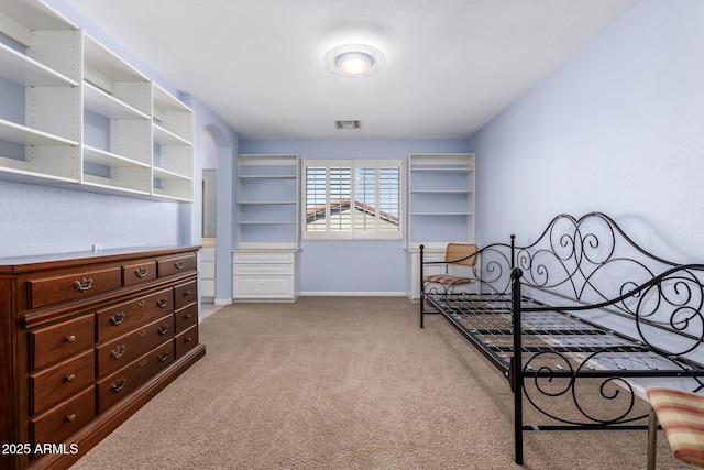 bedroom featuring light carpet