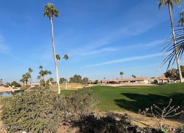 view of property's community featuring a water view and a yard