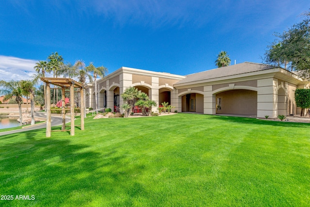 mediterranean / spanish house featuring a water view, a front lawn, and a playground