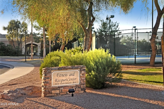 view of community featuring tennis court