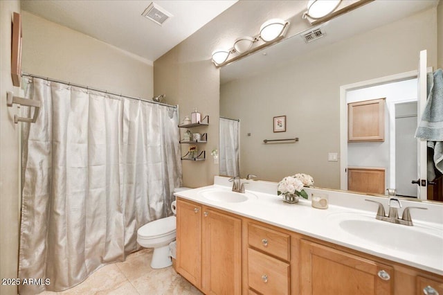 bathroom with double vanity, a sink, and visible vents