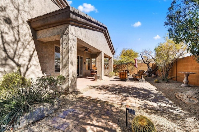 view of patio with a fenced backyard and ceiling fan