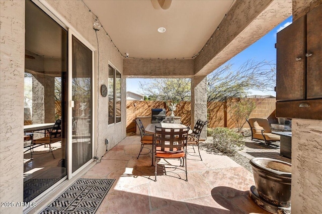 view of patio / terrace with outdoor dining area and fence