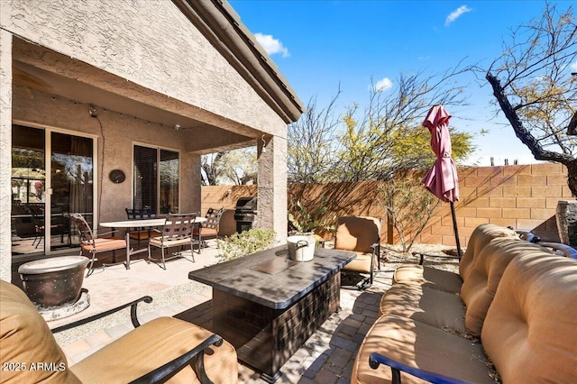 view of patio featuring fence, an outdoor living space, and outdoor dining space