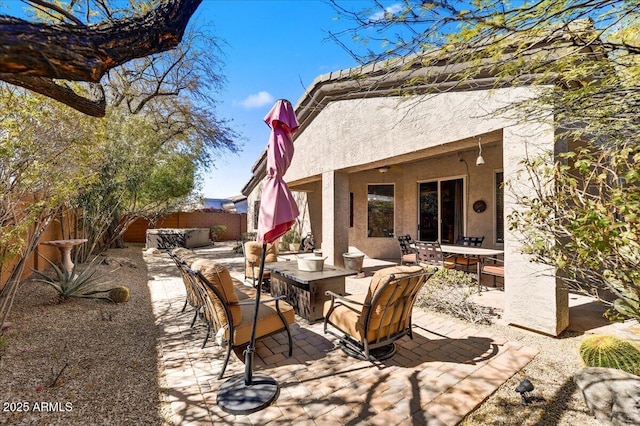 view of patio with outdoor dining area, a fenced backyard, and an outdoor hangout area