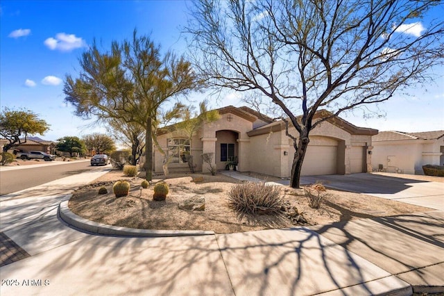 mediterranean / spanish-style house featuring a garage, driveway, and stucco siding