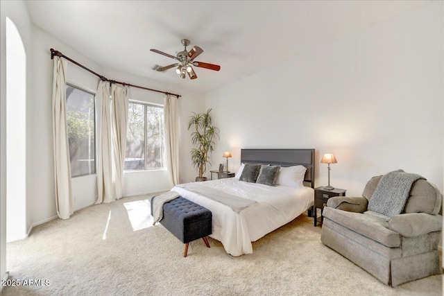 carpeted bedroom featuring ceiling fan and visible vents