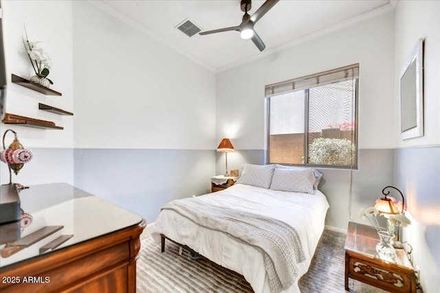 bedroom featuring baseboards, visible vents, ceiling fan, wood finished floors, and crown molding