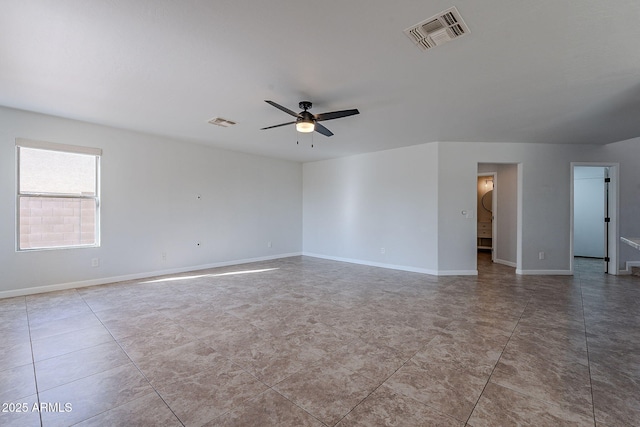 tiled spare room with ceiling fan