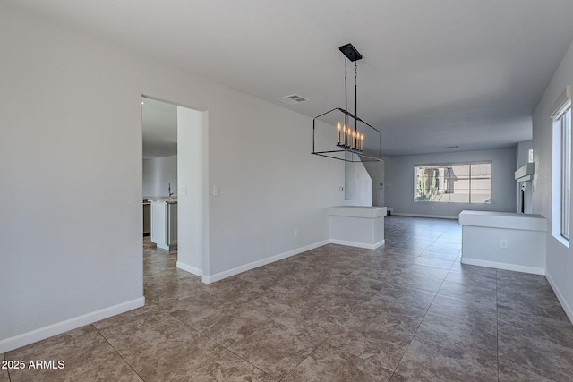 unfurnished dining area with a notable chandelier