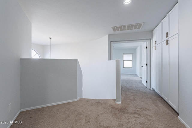 hallway with light carpet