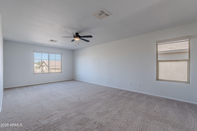 spare room with ceiling fan and light colored carpet