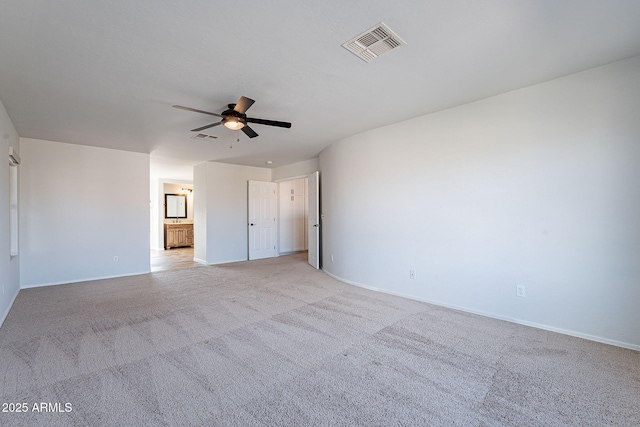 spare room with light carpet and ceiling fan