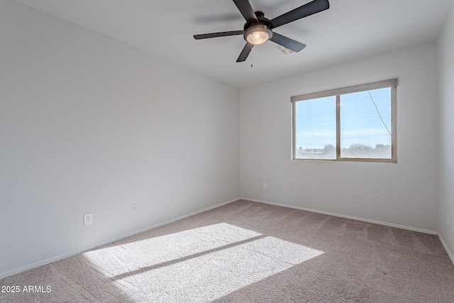 spare room featuring ceiling fan and carpet floors