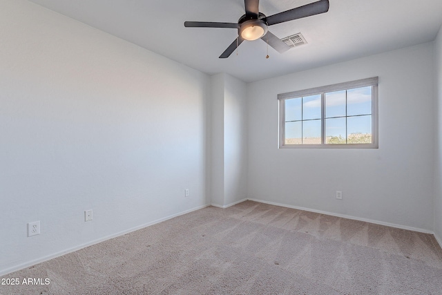 unfurnished room with ceiling fan and light carpet