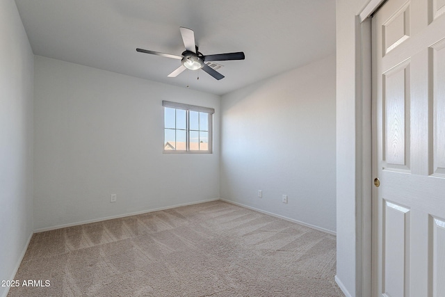 unfurnished room featuring light carpet and ceiling fan