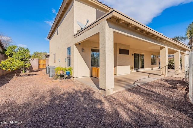 back of property with a patio area and cooling unit