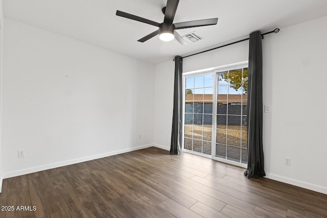 empty room featuring ceiling fan and dark hardwood / wood-style flooring