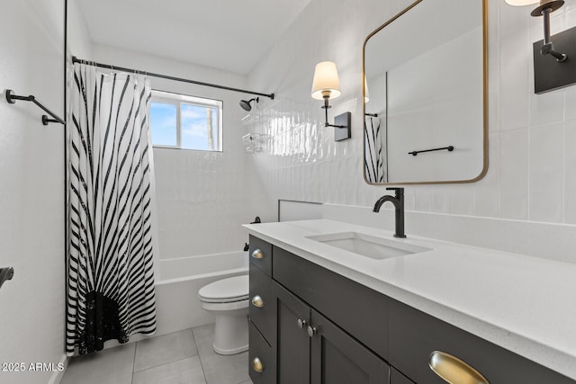 full bathroom with tile patterned flooring, toilet, shower / tub combo with curtain, vanity, and tile walls