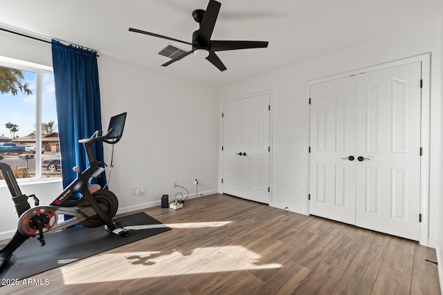 exercise area with ceiling fan and wood-type flooring