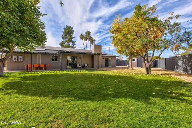 view of yard with a storage unit and a patio area