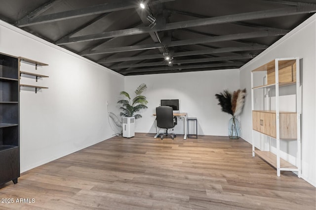 unfurnished office with hardwood / wood-style flooring and vaulted ceiling