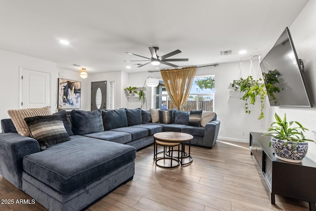 living room with hardwood / wood-style floors and ceiling fan