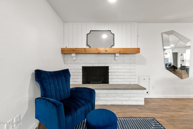 sitting room featuring a fireplace and hardwood / wood-style floors