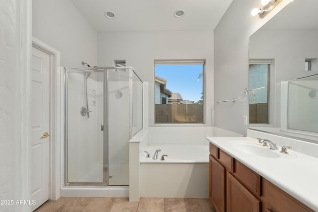 full bath with a garden tub, a shower stall, tile patterned flooring, and vanity