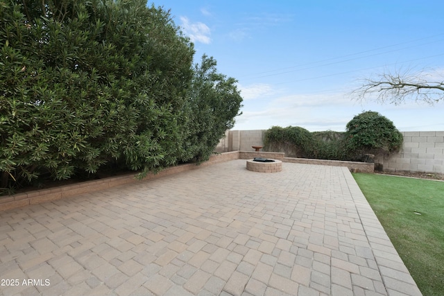 view of patio / terrace with an outdoor fire pit and a fenced backyard