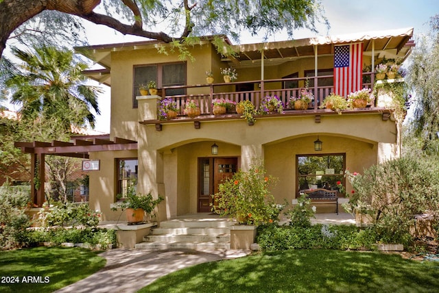 back of house featuring a balcony