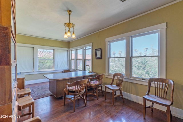 office space featuring dark hardwood / wood-style flooring, crown molding, and a notable chandelier