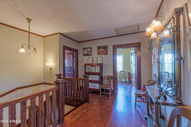 interior space with crown molding, dark hardwood / wood-style flooring, and an inviting chandelier