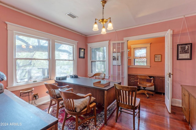 dining room featuring dark hardwood / wood-style flooring, crown molding, and a chandelier