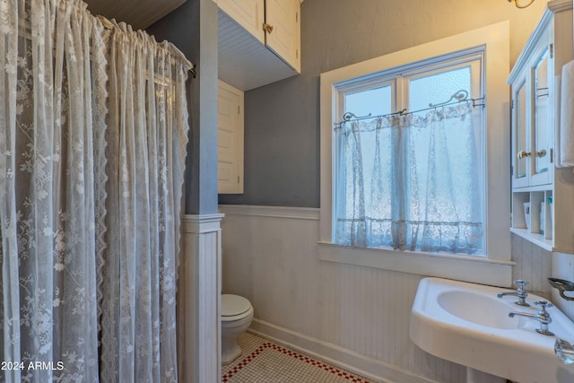 bathroom featuring tile patterned floors, sink, and toilet