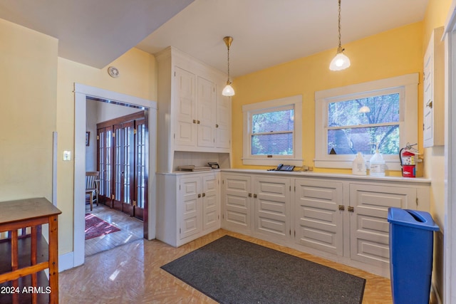 kitchen with pendant lighting, decorative backsplash, and white cabinetry