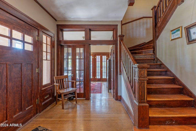 foyer featuring light hardwood / wood-style floors and french doors