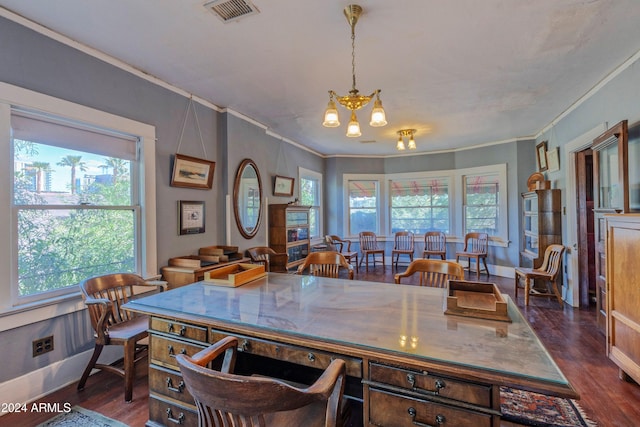 dining area with dark hardwood / wood-style floors, an inviting chandelier, and ornamental molding