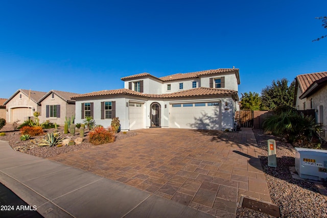 mediterranean / spanish home featuring a garage