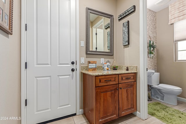 bathroom with tile patterned floors, vanity, and toilet