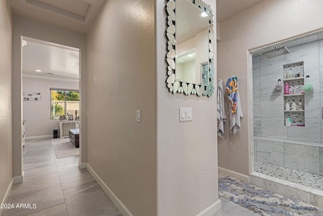 hallway featuring crown molding and tile patterned flooring