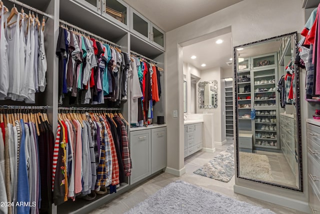 walk in closet with light tile patterned floors