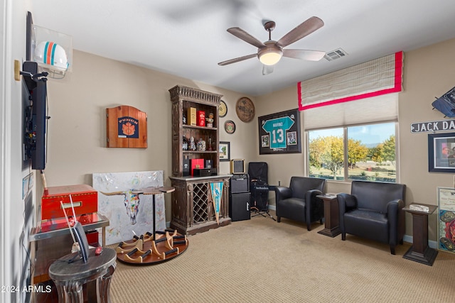 sitting room featuring carpet flooring and ceiling fan