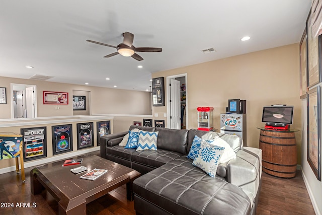 living room featuring ceiling fan and dark hardwood / wood-style flooring