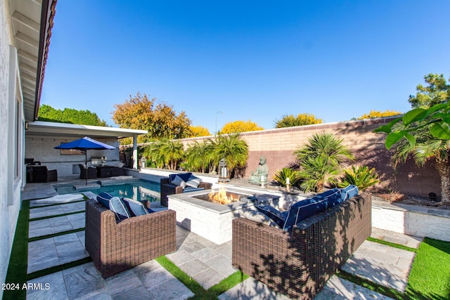 view of swimming pool featuring area for grilling, a patio area, and an outdoor fire pit