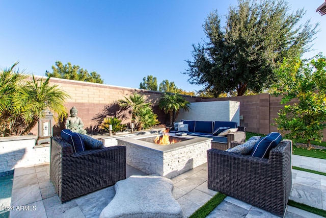 view of patio / terrace featuring an outdoor living space with a fire pit