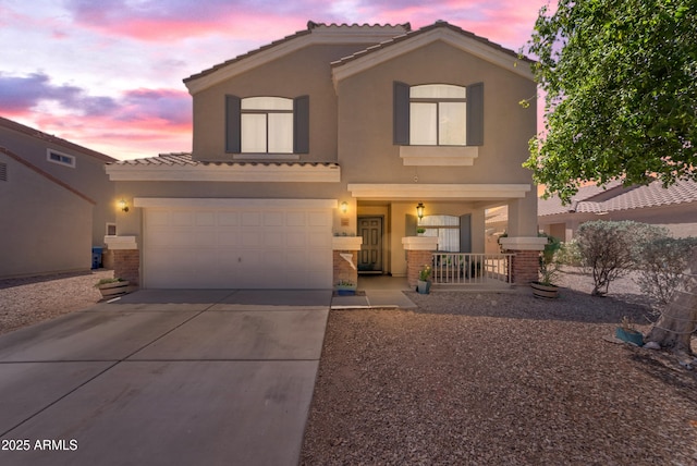 23693 W Grove St, Buckeye, AZ 85326 - view of front facade with driveway, stucco siding, covered porch, and a tiled roof